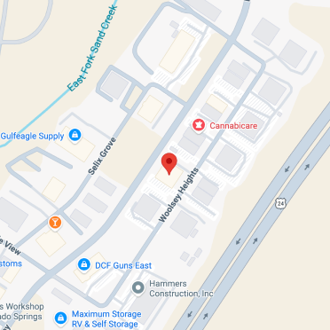 Map showing a pin dropped on Woolsey Heights near Self Grove, close to businesses like Cannabicare, Gulf Eagle Supply, and DCF Guns East, adjacent to East Fork Sand Creek and Highway 24.